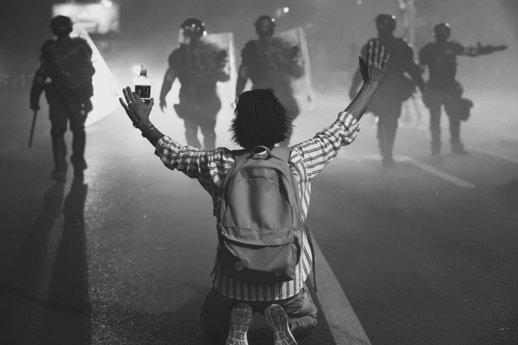 Student raising hands being arrested by Serbian police